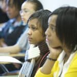 A group of students is sitting and facing to the left side.