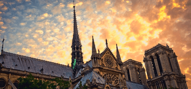 A chapel with a sunset in the background.