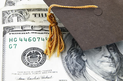 Graduation cap tassel covering the upper right side of one hundred dollar bill.