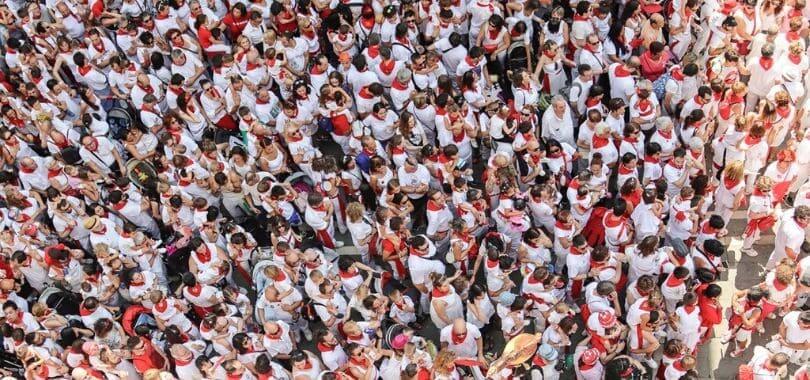 A crowd of people all wearing white and red.