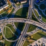 An aerial shot of cars driving on a highway.