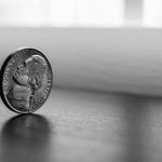 A nickel balancing on a table.