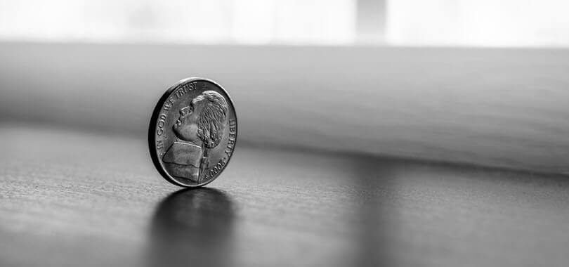 A nickel balancing on a table.