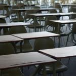 An empty classroom filled with desks and chairs.