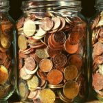 Three jars of coins in a row.