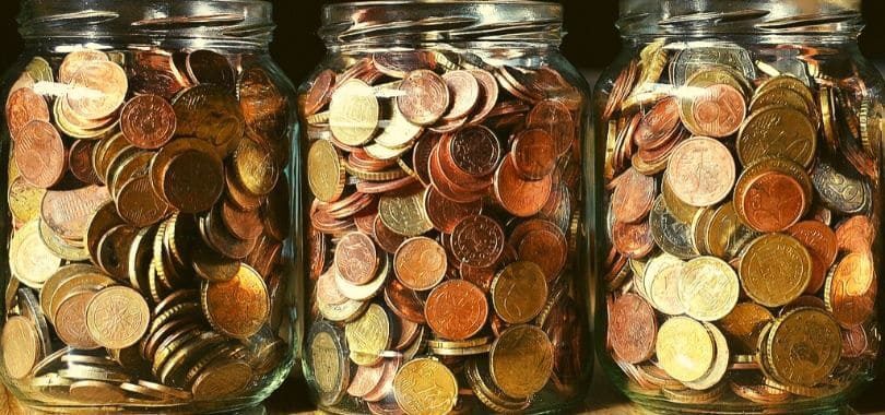 Three jars of coins in a row.