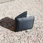 A black wallet on the ground.