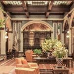 A hotel lobby decorated with orange furniture.