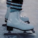 A close-up shot of an ice skater's skates.