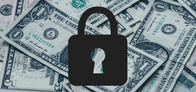 Dollar bills with a dark lock over them.