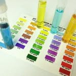 Tube apparatus with colored water placed over a water test chart.