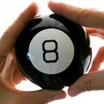 Both hands holding a number 8 billiard ball.