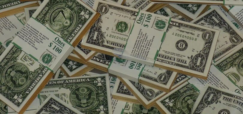 Stacks of dollar bills piled on top of each other.