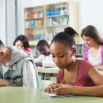 Students are writing on their desks.