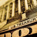 Dollar bill macro shot showing "US Treasury" print.