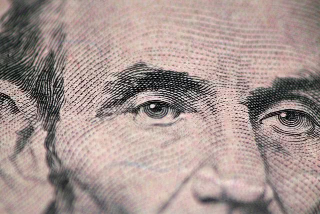 Close up of Abraham Lincoln in 5 dollar bill.