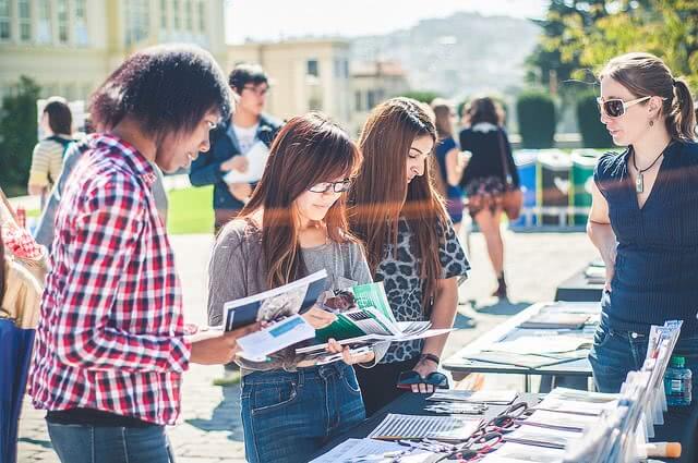 Students looking at the magazines during study abroad fair.