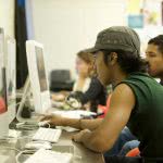 Students studying in the classroom using computer.