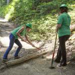 Two female volunteers are repairing the road of the Wonderland Trail.