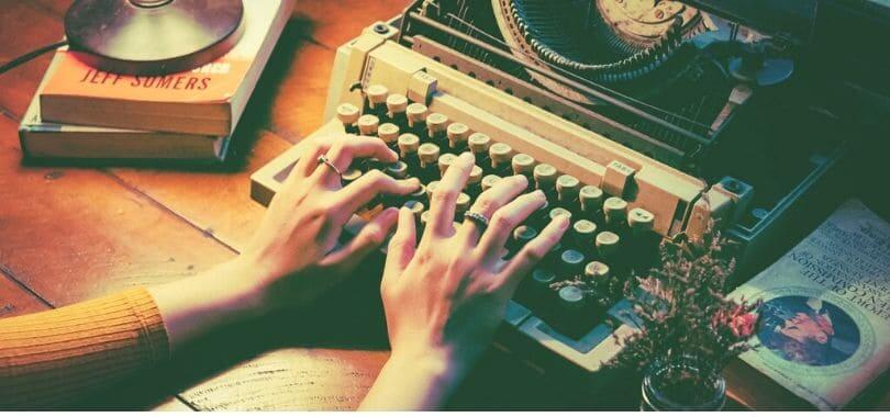 A person typing on a typewriter.