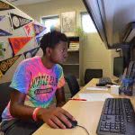 Male student seriously working on his computer.