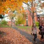 Students on campus in fall -- November is national scholarship month