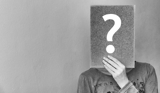 Student with question mark in front of his face