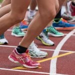 Students racing on a field track.