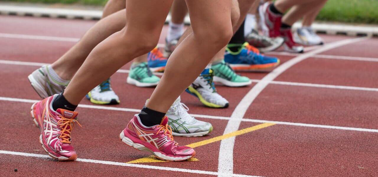 Students racing on a field track.