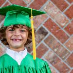 Young boy in grad cap and gown - many families wonder about the best 529 plans