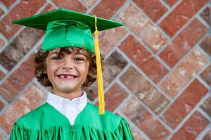 Young boy in grad cap and gown - many families wonder about the best 529 plans