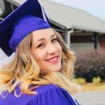 A graduating student looking over their shoulder.