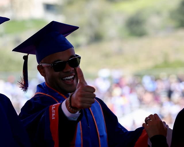 A student at graduation, considering Earnest student loan refinance