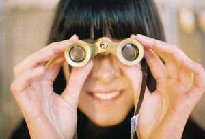 Woman holding binoculars - how do scholarships work? we can help you search