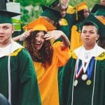 Students standing together in graduation robes.