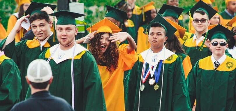Students standing together in graduation robes.