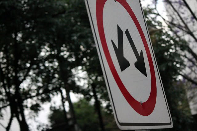 Down arrows on a sign - here's how to lower student loan payments.