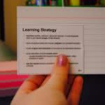 Student holds up her flashcard as she studies for the SAT test