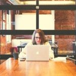 A student sitting at a desk with a laptop.