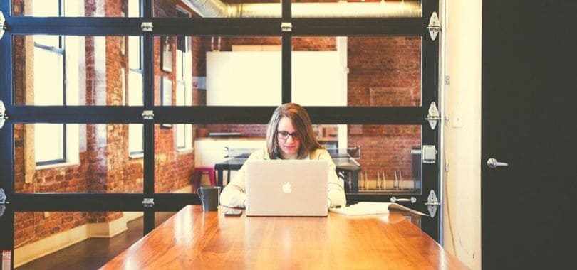 A student sitting at a desk with a laptop.