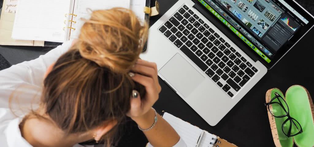 High school student sitting at a desk with a laptop.