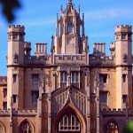 A shot of a college with leaves in the forefront.