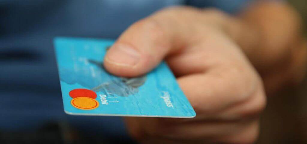 A person holding a credit card.