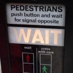 A pedestrian crossing button that says "wait."