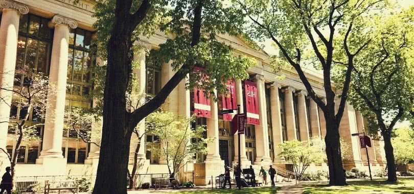 College students walking in front of a Harvard Law School building.