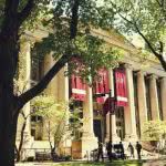 College students walking in front of a Harvard Law School building.