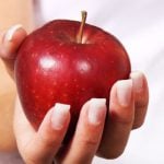 College student holding an apple