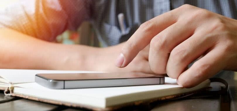 College student filing the FAFSA on his phone.