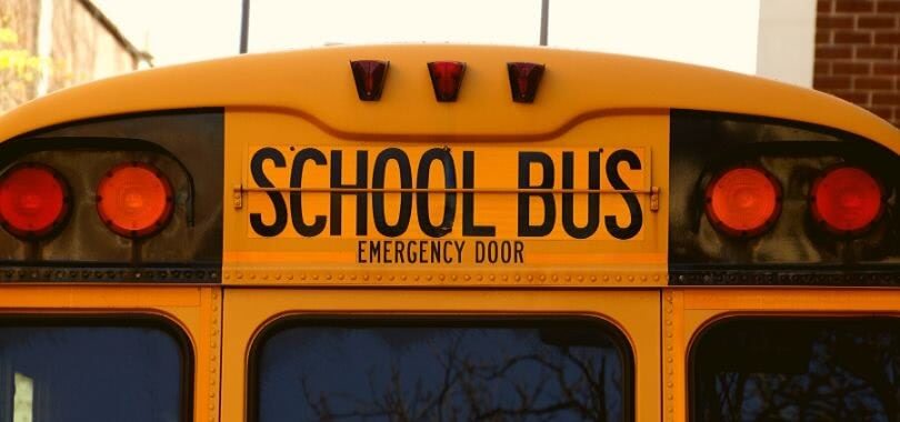 The back of a yellow school bus.