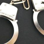 A pair of silver handcuffs.